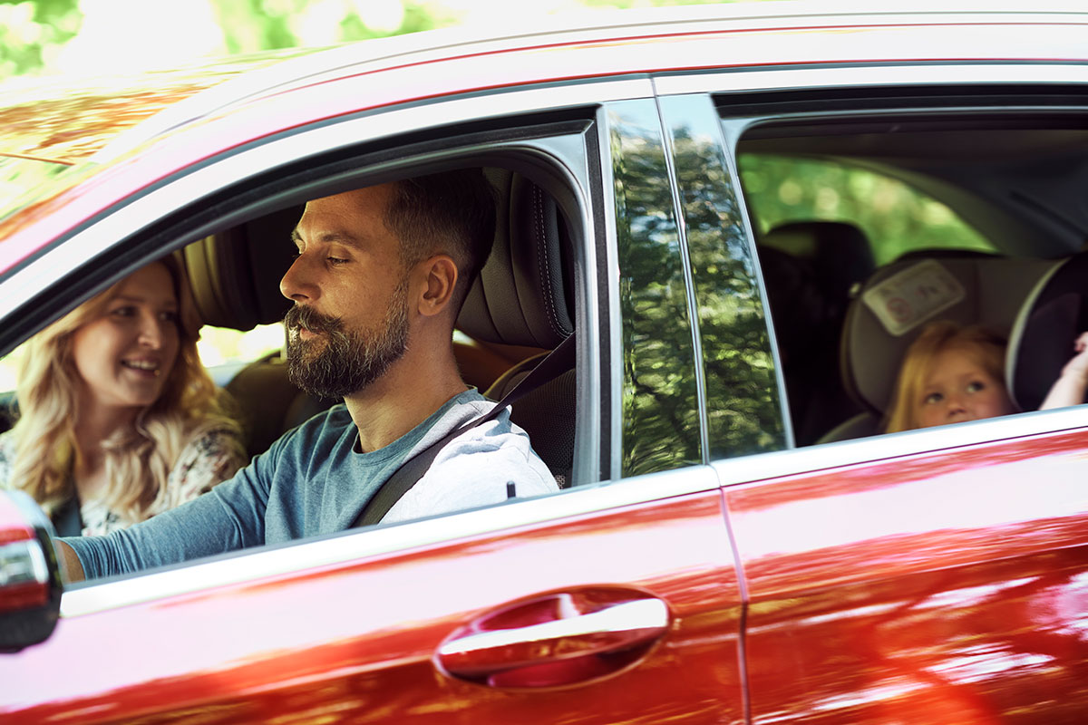 family driving in a car protected by insurance